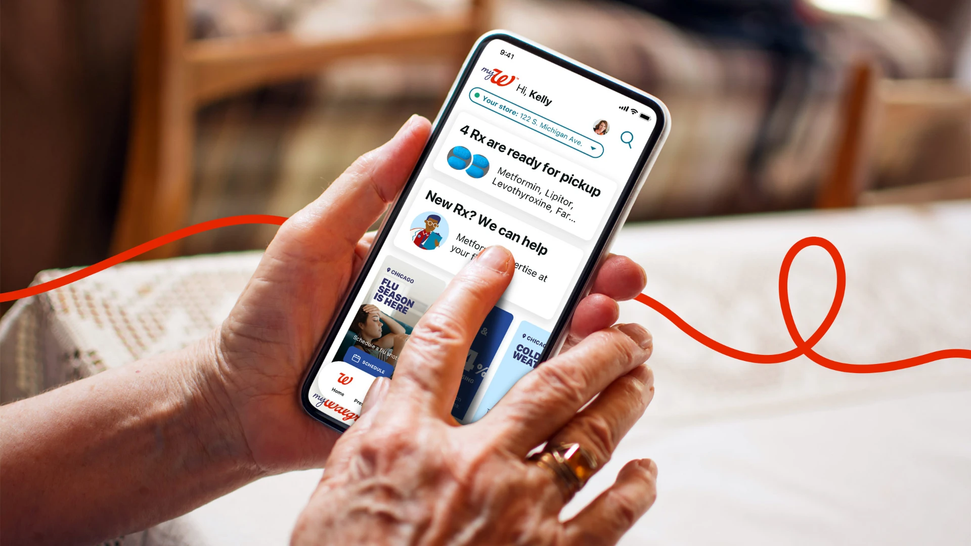 Hands holding a phone showing the myWalgreens app with a prescription ready for pickup and a new-prescription support card, with a red ribbon line curving across the frame