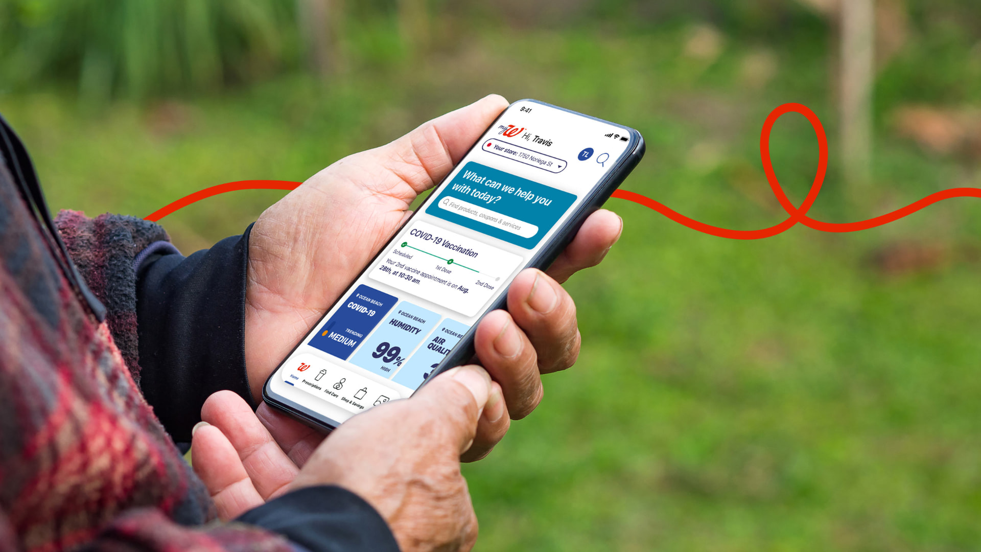Hands holding a phone showing the myWalgreens app with COVID-19 vaccine and health information cards